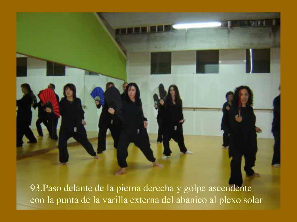 93.Paso delante de la pierna derecha y golpe ascendente con la punta de la varilla externa del abanico al plexo solar