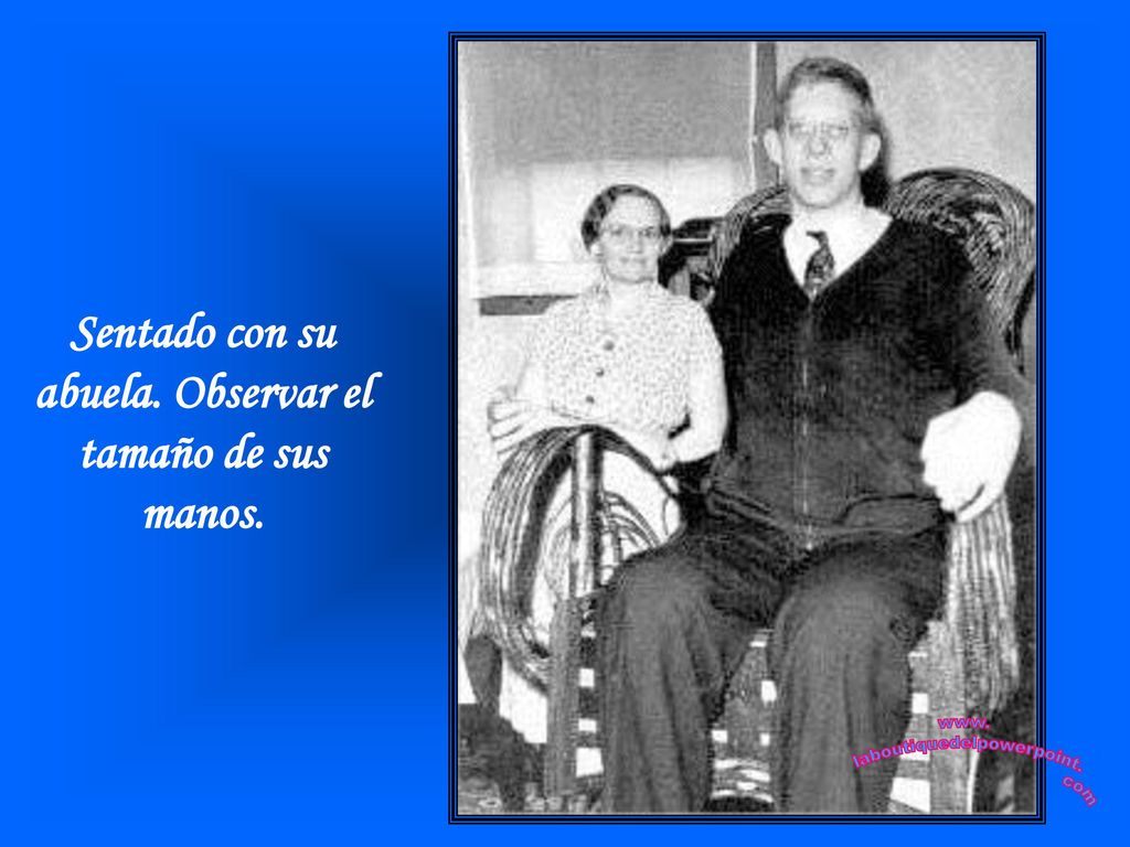 Sentado con su abuela. Observar el tamaño de sus manos.