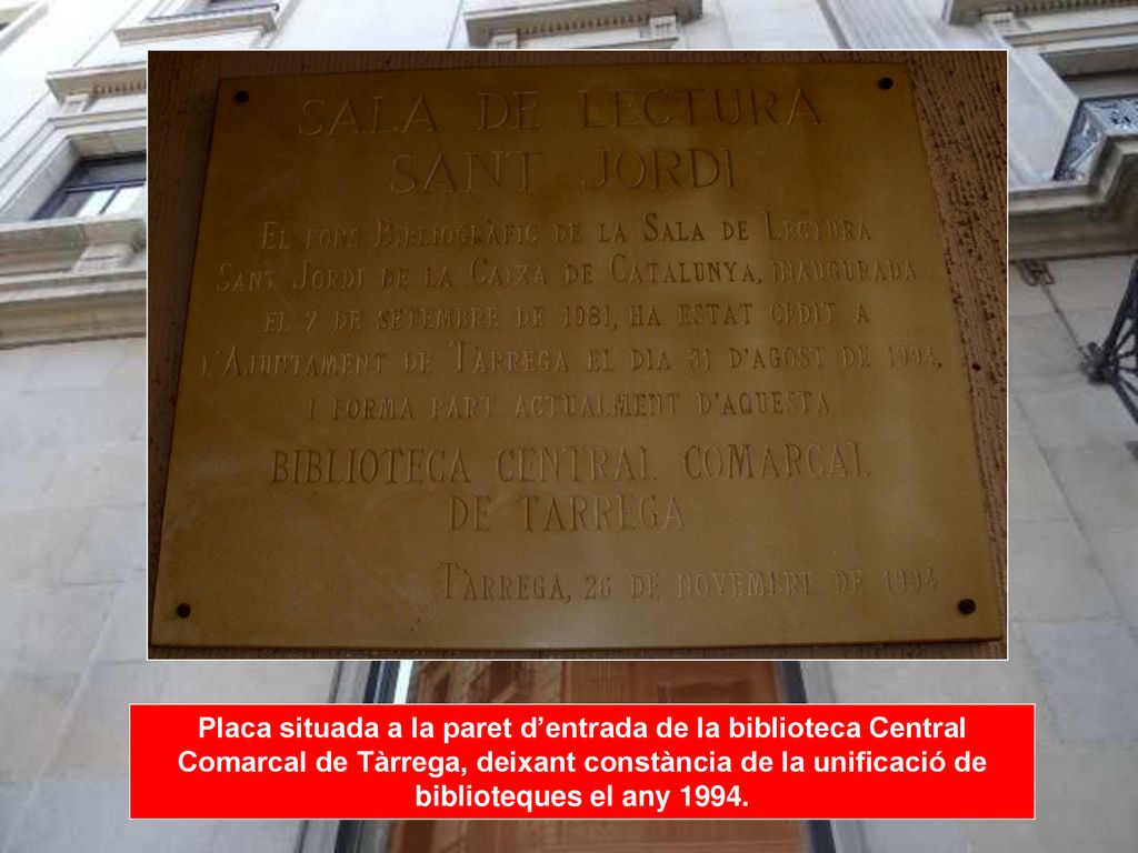 Placa situada a la paret d’entrada de la biblioteca Central Comarcal de Tàrrega, deixant constància de la unificació de biblioteques el any 1994.