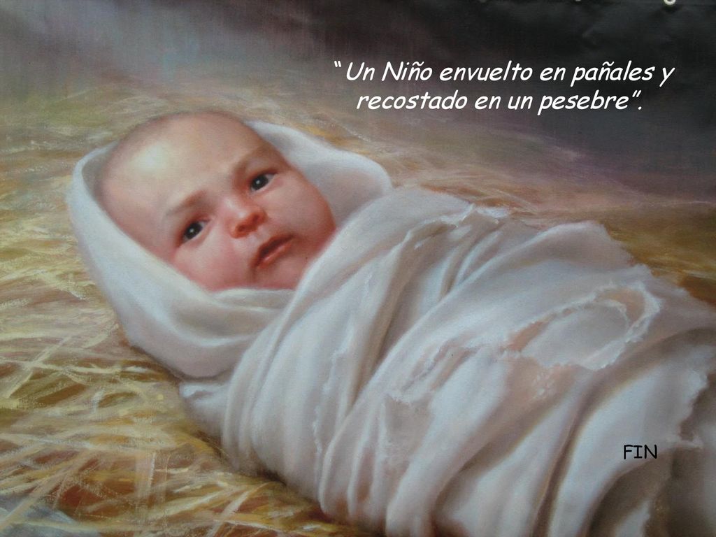 Un Niño envuelto en pañales y recostado en un pesebre .