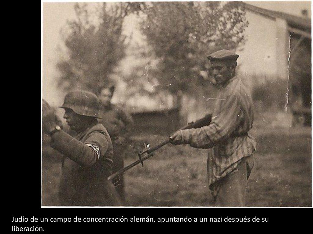 Judío de un campo de concentración alemán, apuntando a un nazi después de su liberación.
