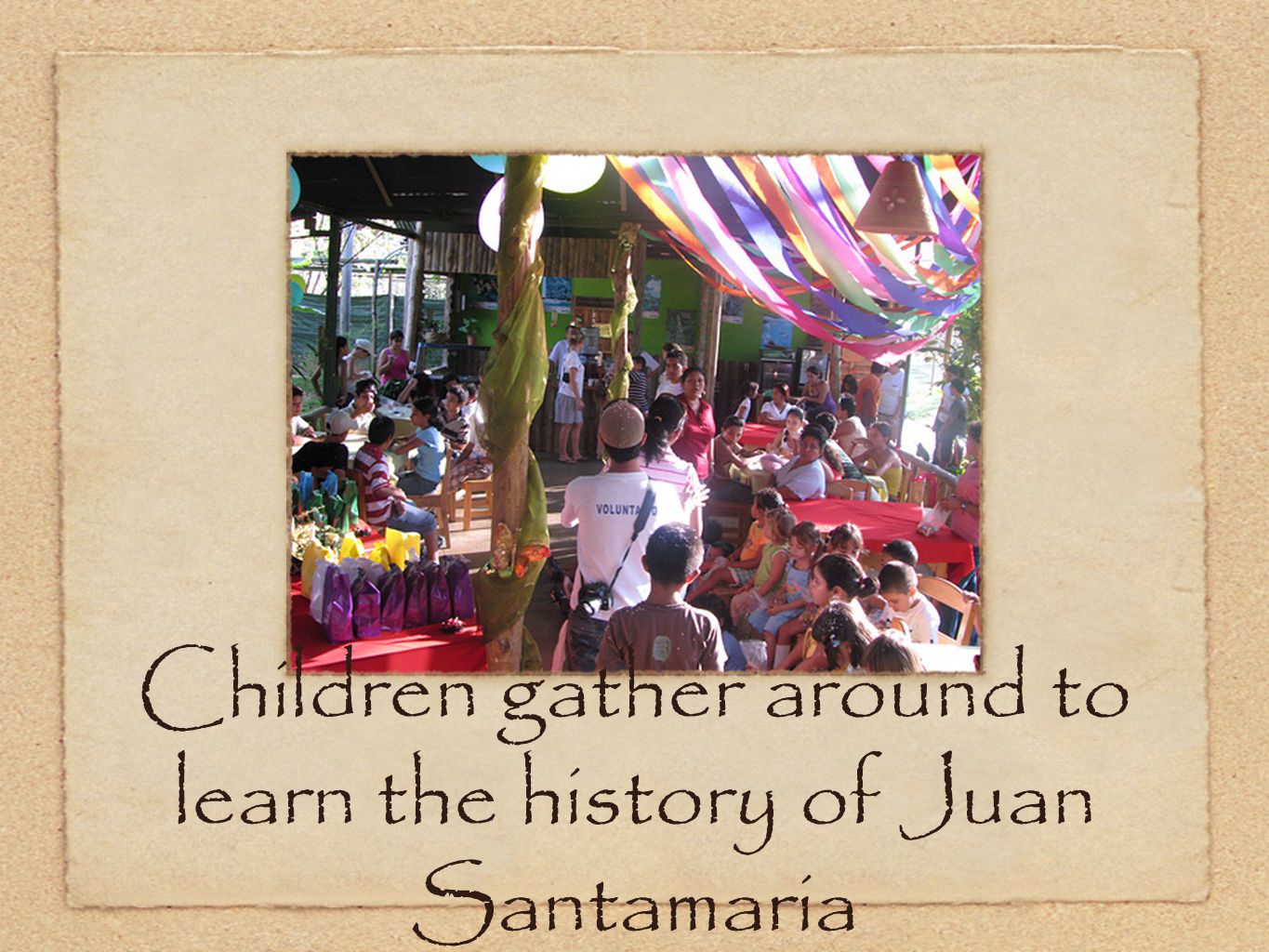 Children gather around to learn the history of Juan Santamaria